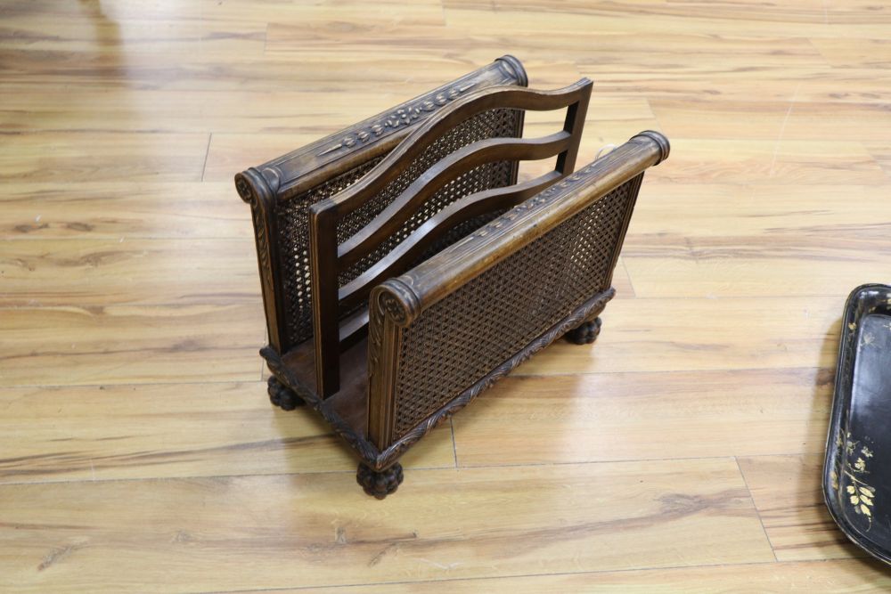 A large papier mache gilt-decorated tray and a 1930s carved oak Canterbury, with double rattan sides